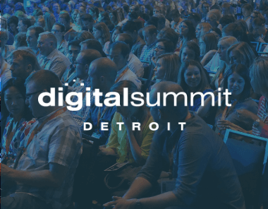 A large audience sits in rows at the Digital Summit Detroit conference, with the event logo overlaid on the image. People are engaged and facing the stage, creating a lively atmosphere.
