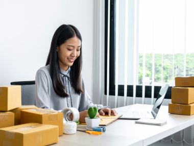 Business woman smiling at laptop