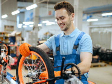 man assembling bike at factory