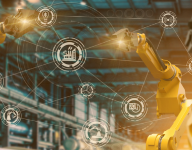 Robotic arms operate in a factory setting, with digital icons and network connections overlaid—representing our New Years Resolution: Industry 4.0. Find out why smart manufacturing and advanced automation are transforming the industry.